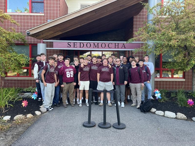 Football players in front of the school