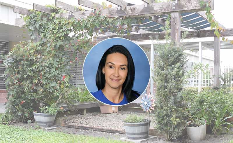 Background photo of Veterans Memorial Elementary School and school principal headshot