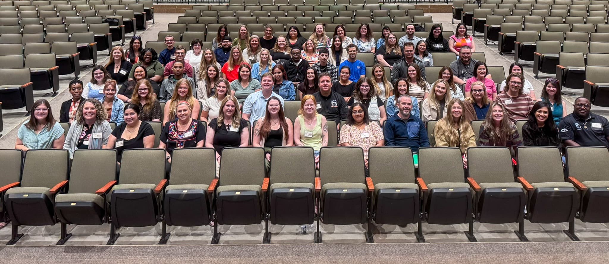group of adults sitting in auditorium