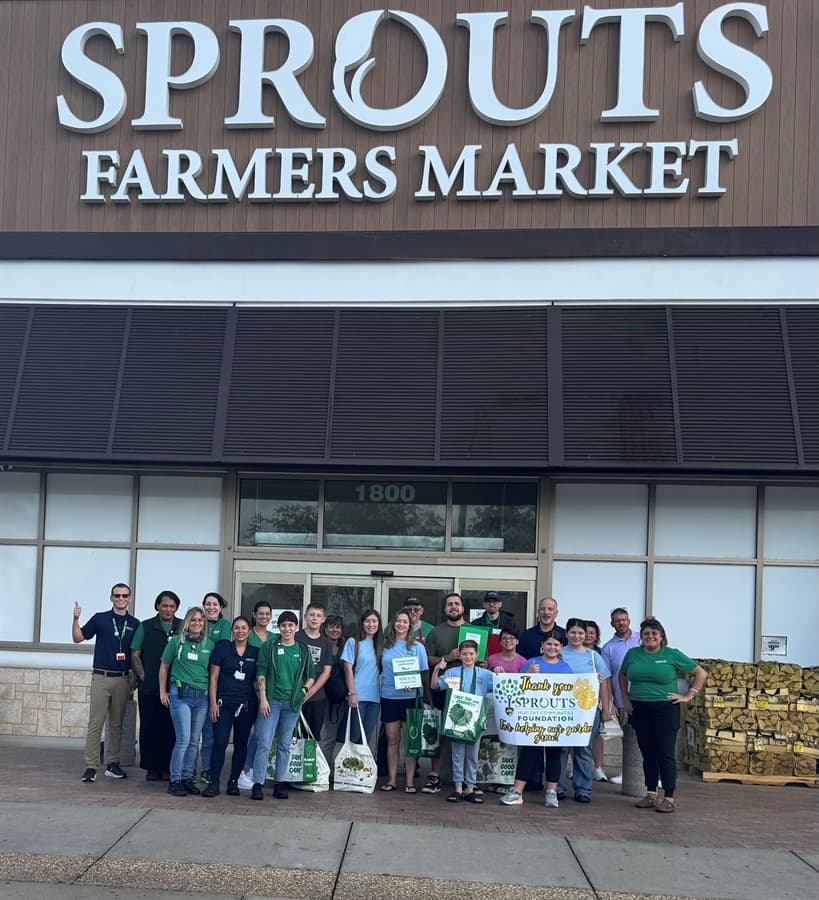 photo of Sprouts workers with Caloosa Middle students and staff