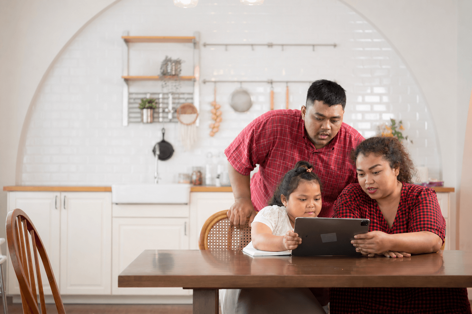 Family using iPad for online school registration