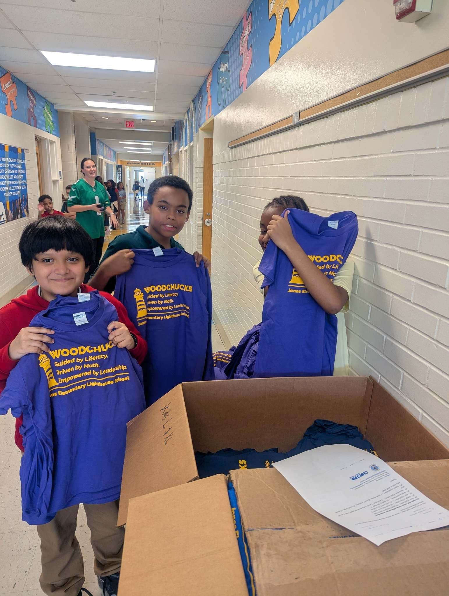 Jones students holding up new shirts