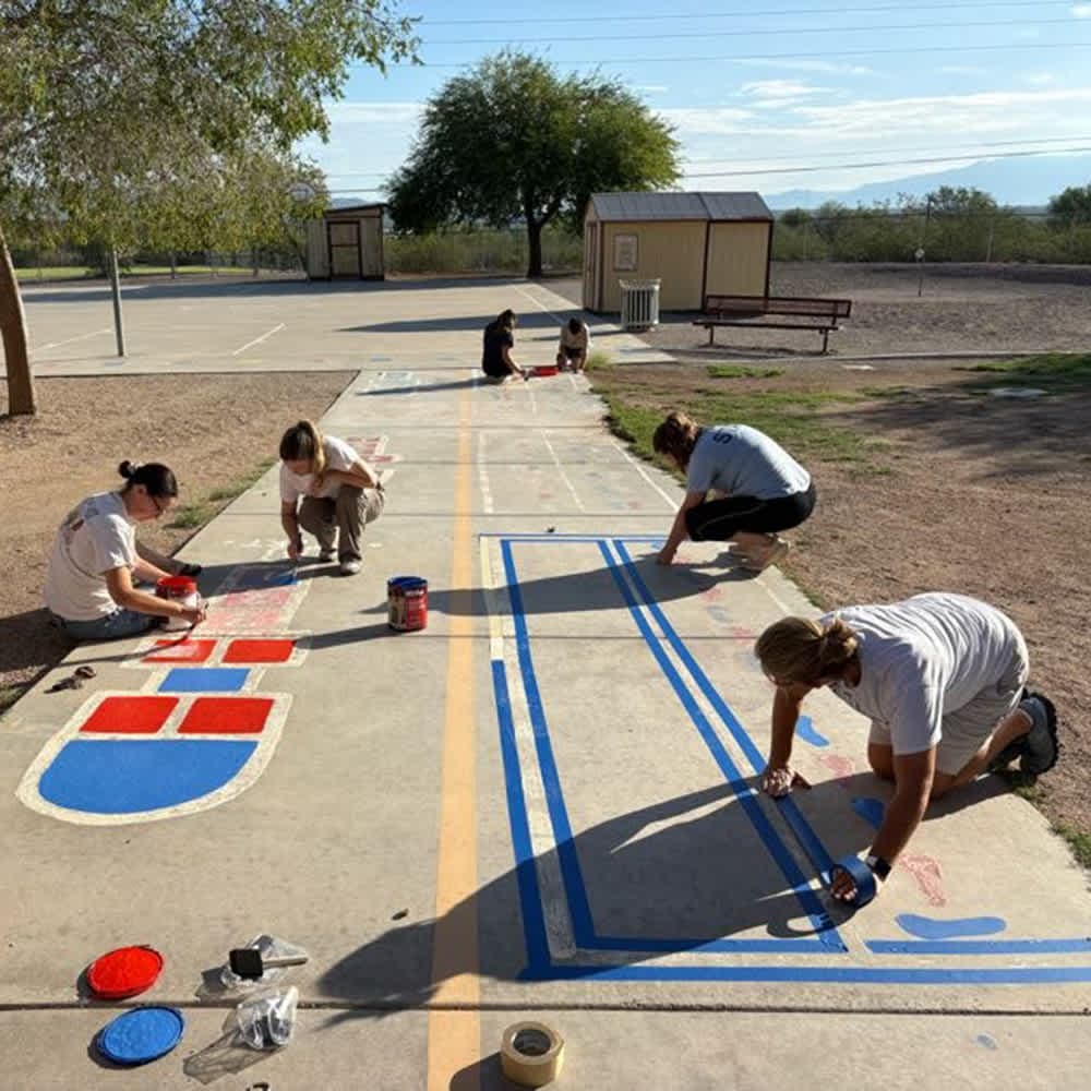 Students help to re-paint playground for 9-11 Day of Service