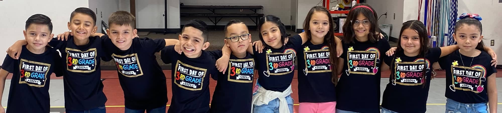 Students in first day of school shirts