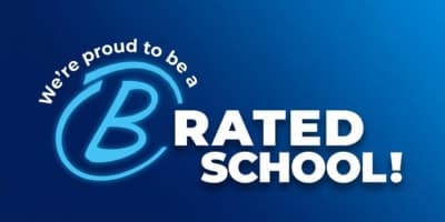 A blue gradient background frames a white text that reads %22We're proud to be a B RATED SCHOOL!%22 with a stylized blue %22B%22 in a circle.
