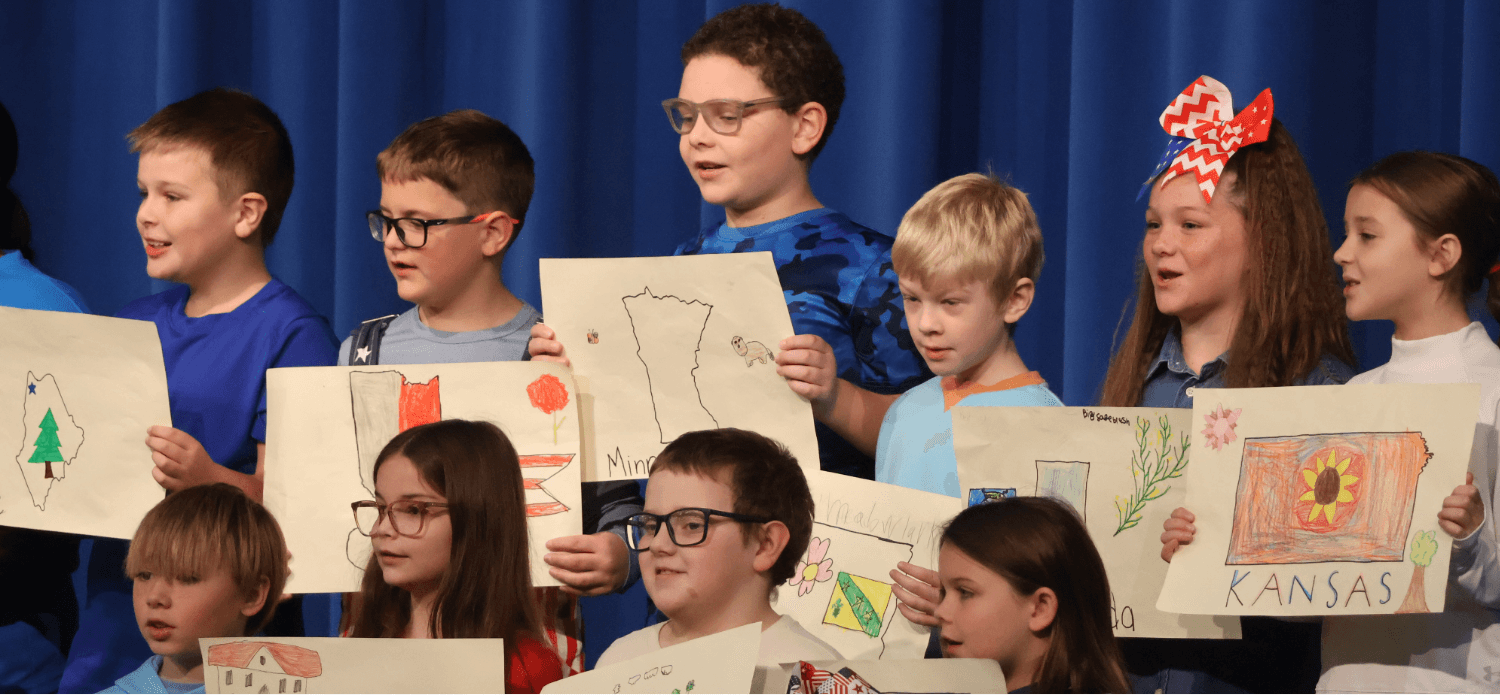 Students perform on stage.