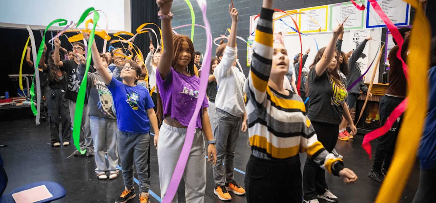 Students waving colorful ribbons in the air