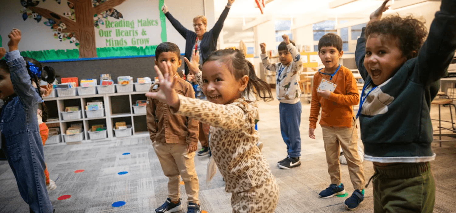 preschool students dancing and smiling
