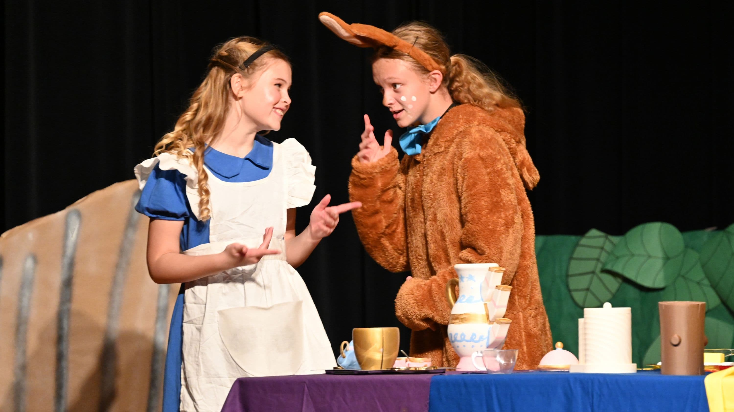 Students on stage performing a play.