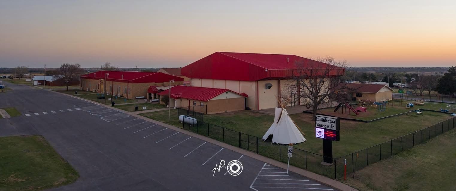 An aerial view shows a building with a red roof