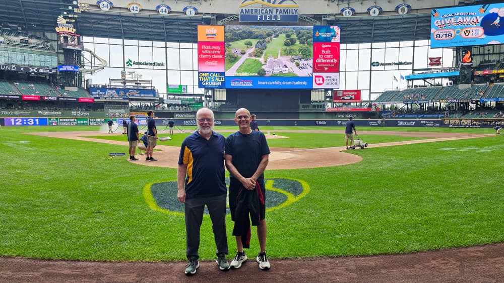 two man stand on American Family Field in Milwaukee near home plate