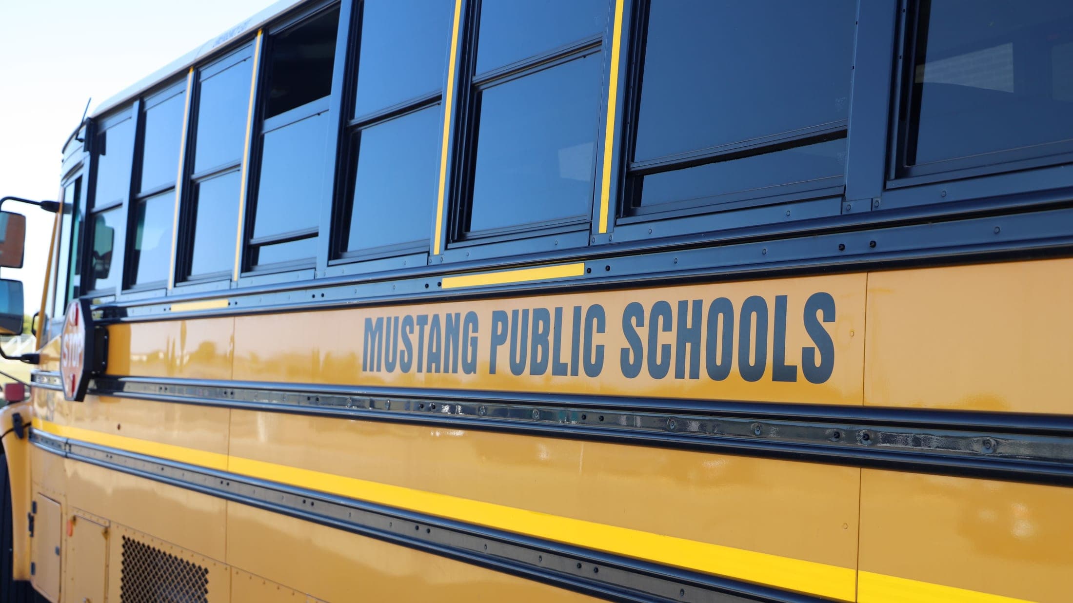 Photo of school bus with Mustang Public Schools displayed