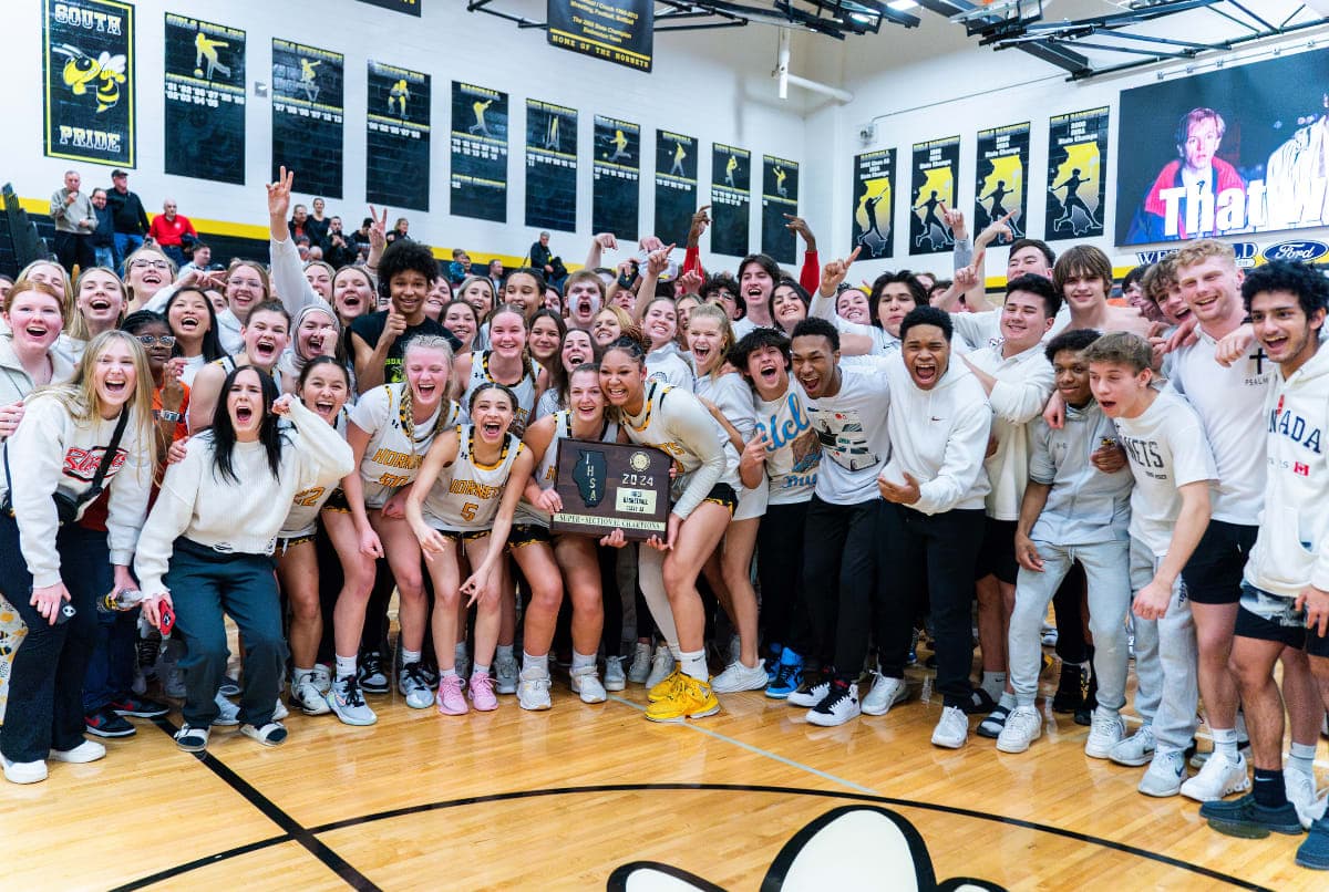 students celebrating girls basketball victory