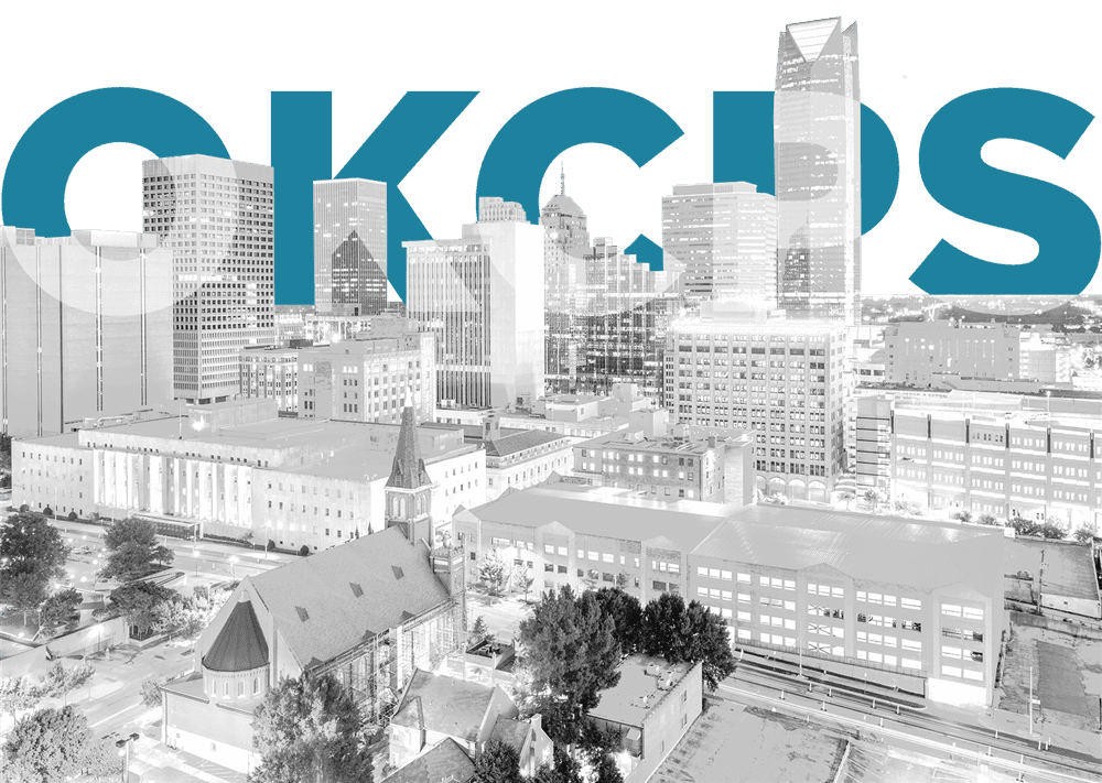A black and white cityscape with a prominent blue %22OKCPS%22 logo overlaid on the skyline, featuring a church in the foreground and modern buildings in the background.