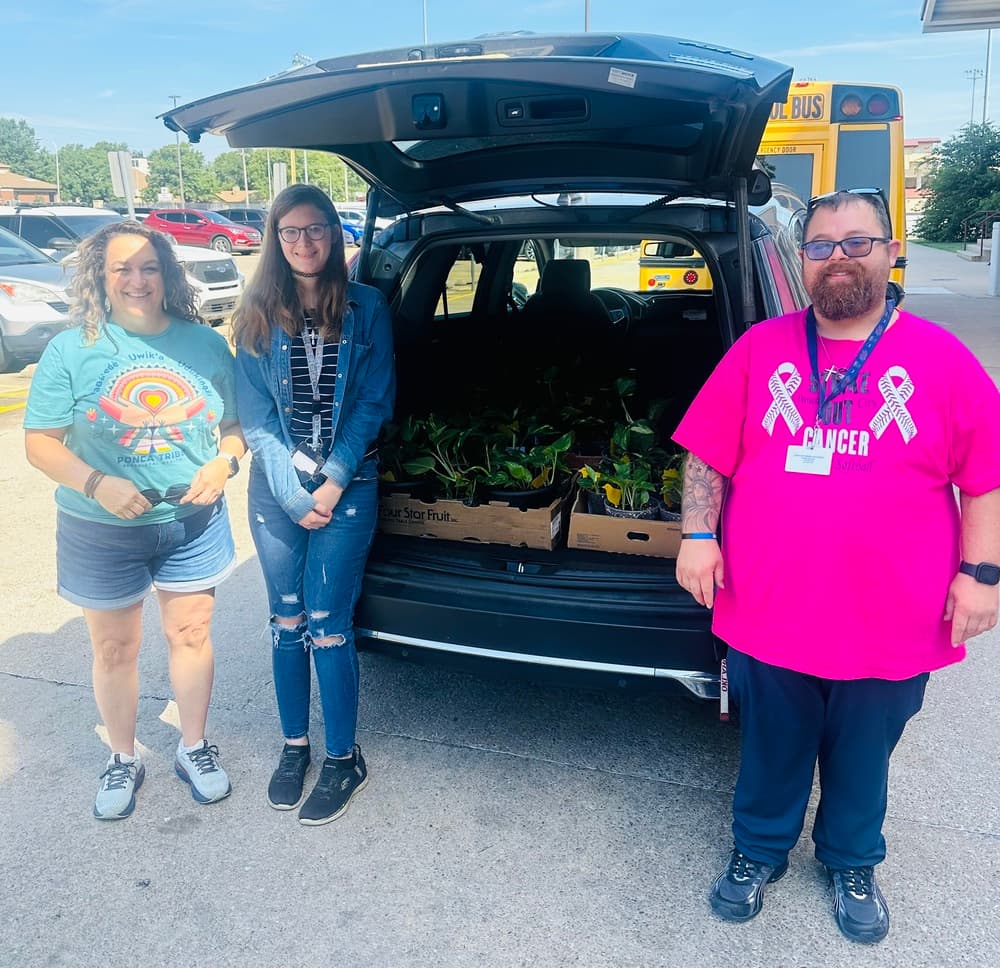 Photo of people with donated plants.