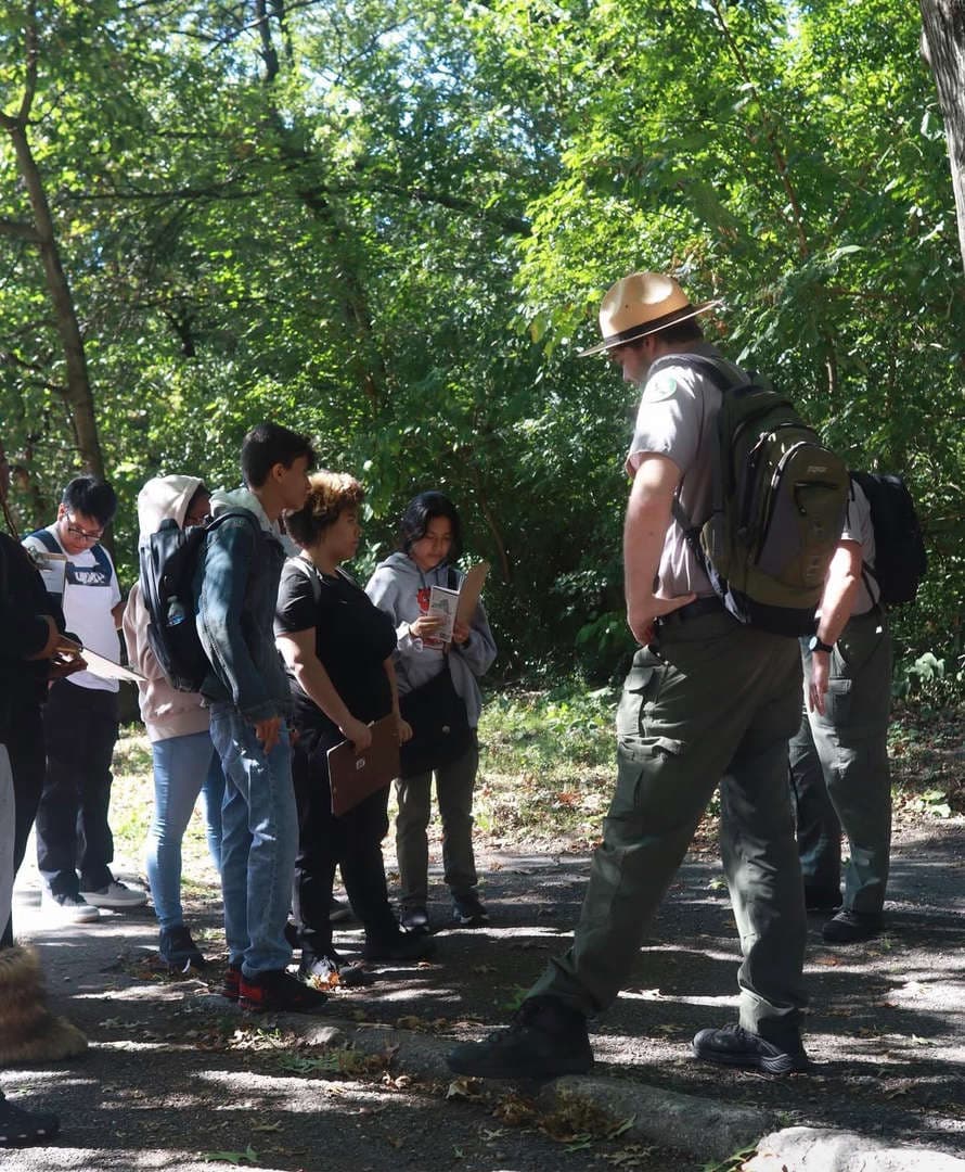 Students standing listening to park representative