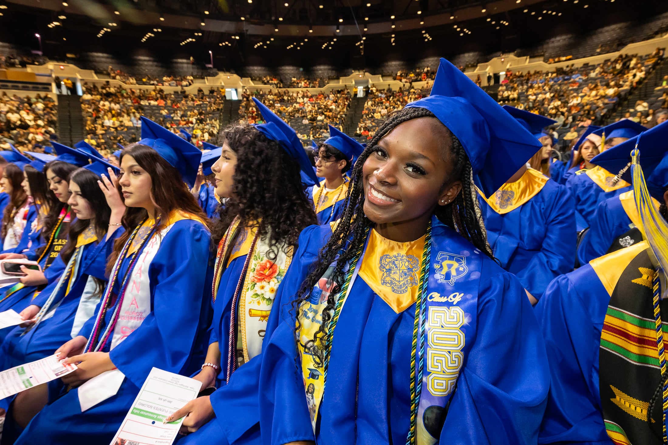 a student smiles at graduation