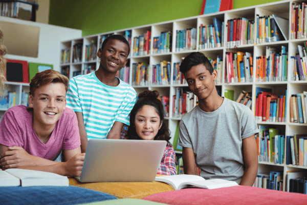 A group of students are sitting in a library.
