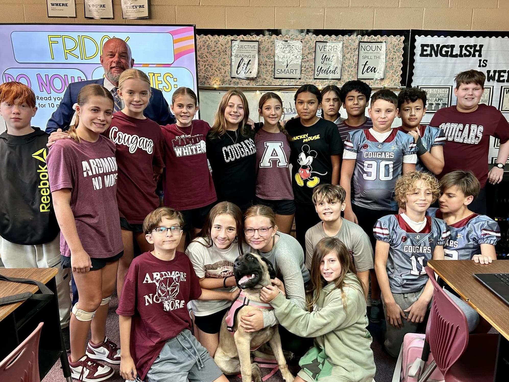 Willard students pose with District Attorney Erik Johnson and Wendy, a therapy dog.