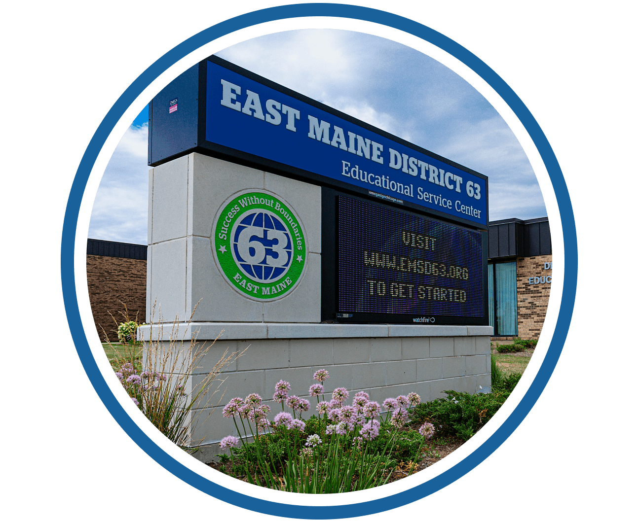 Sign for East Maine District 63 Educational Service Center, with a blue sky background.