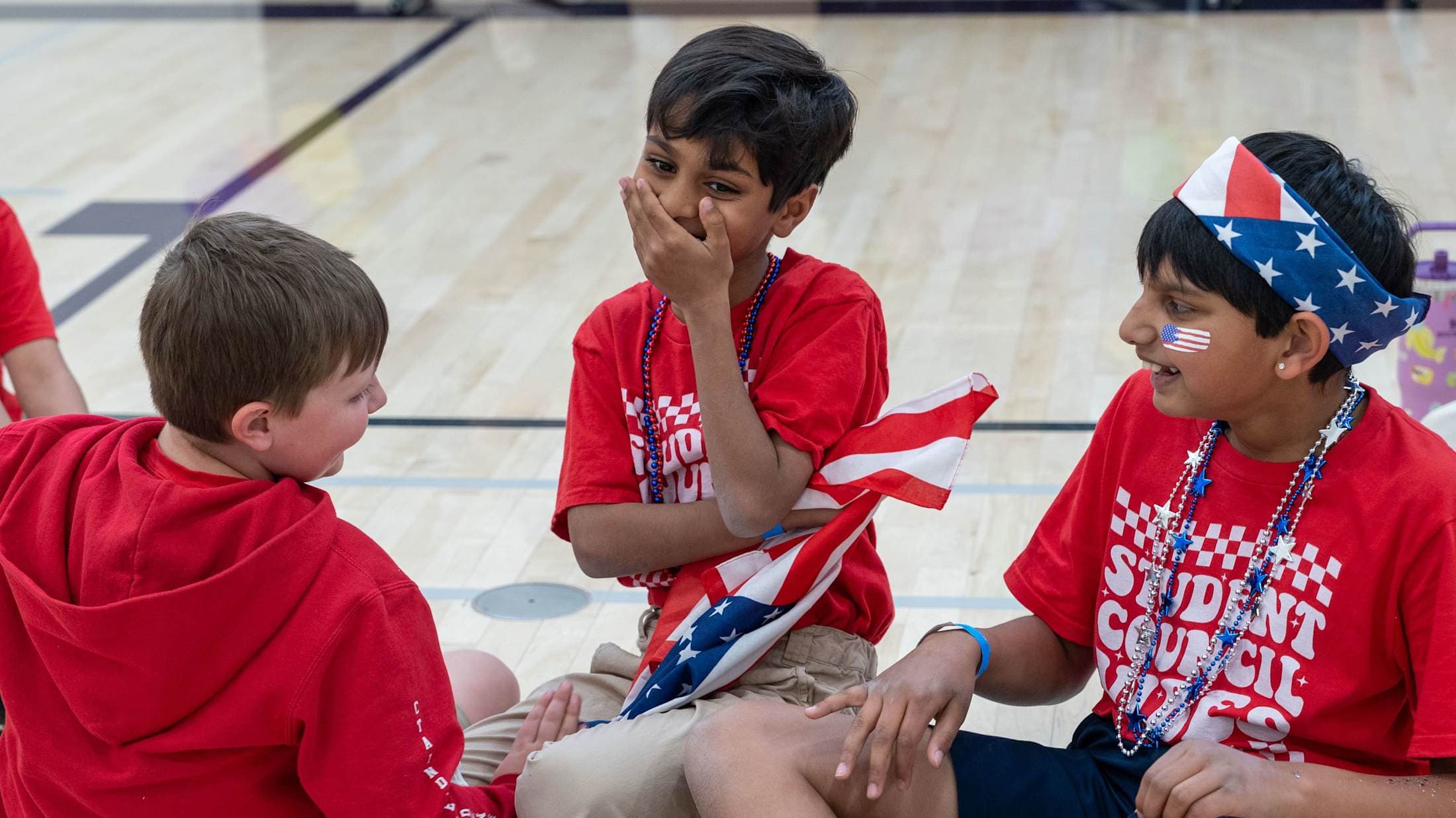 A group of boys laugh during a student government convention.