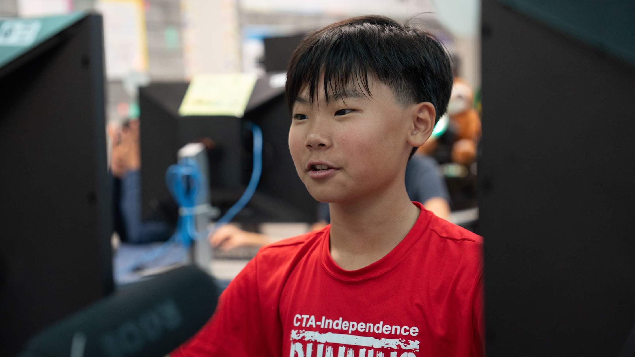A boy works on an assignment on a computer.