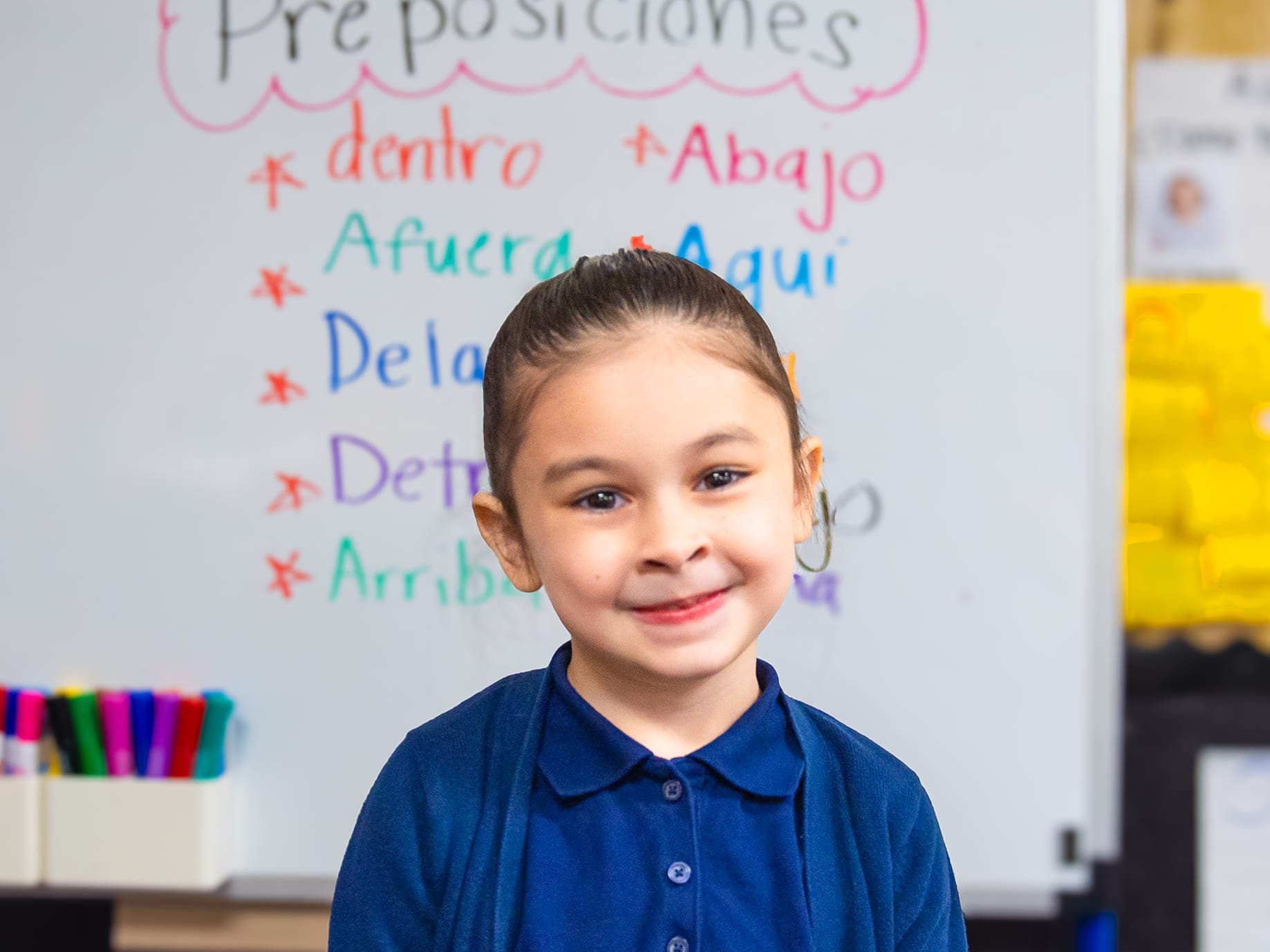 Young student smiling in Spanish classroom