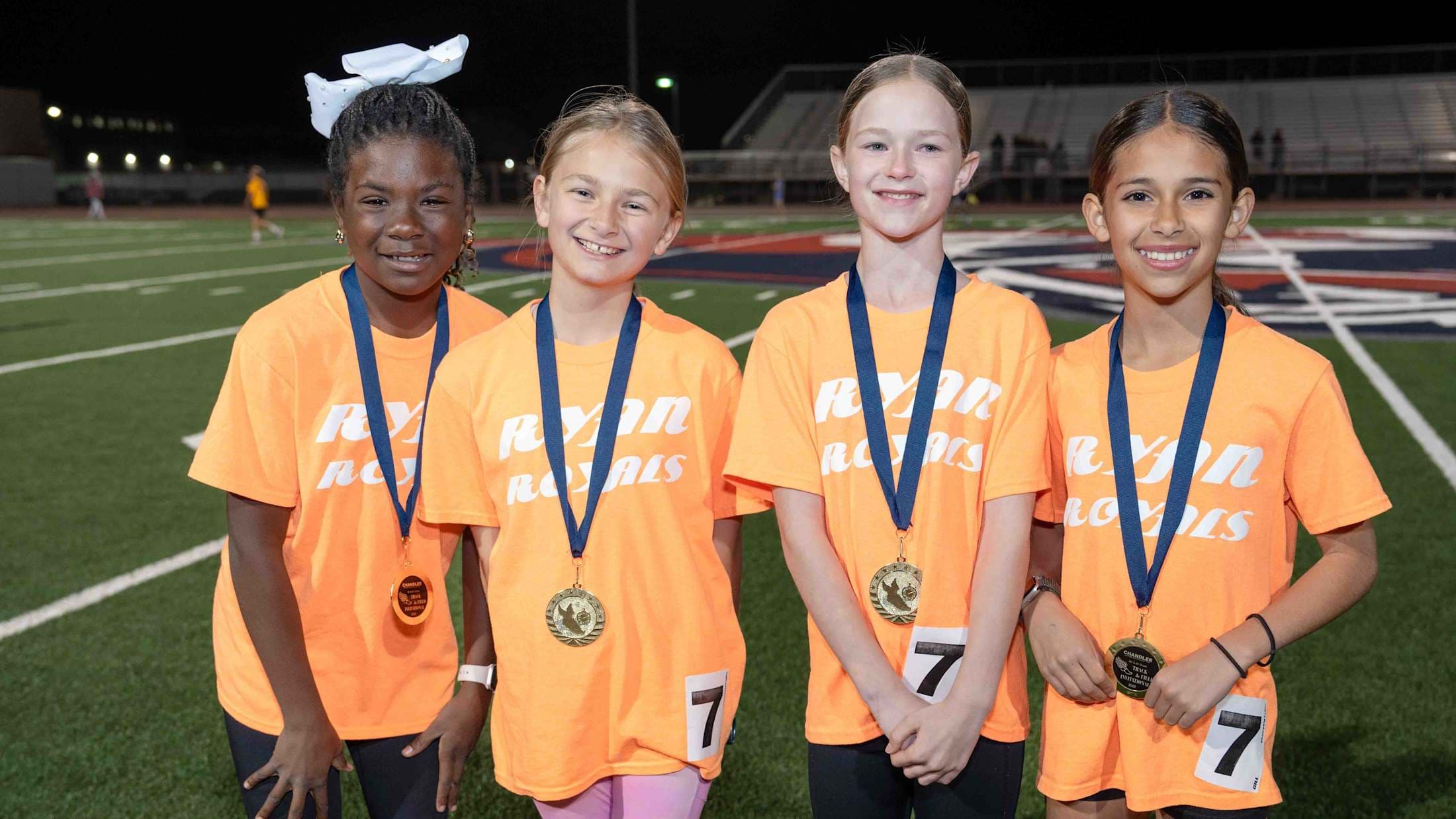 A group photo of elementary track students after winning an event in the 2024-2025 school year.