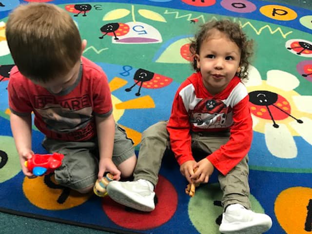 Kids on colorful rug at Judy Sare preschool