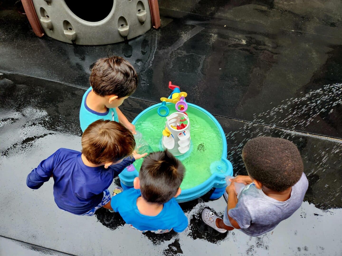 A group of kids playing with water toys.