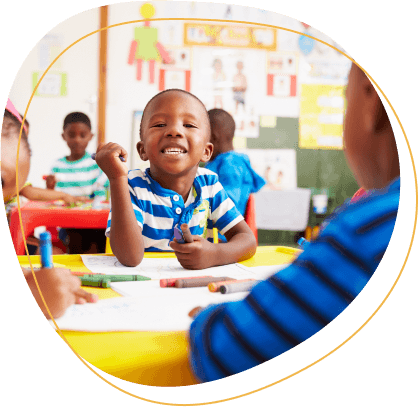 Preschool class in South Africa, boy looking to camera.