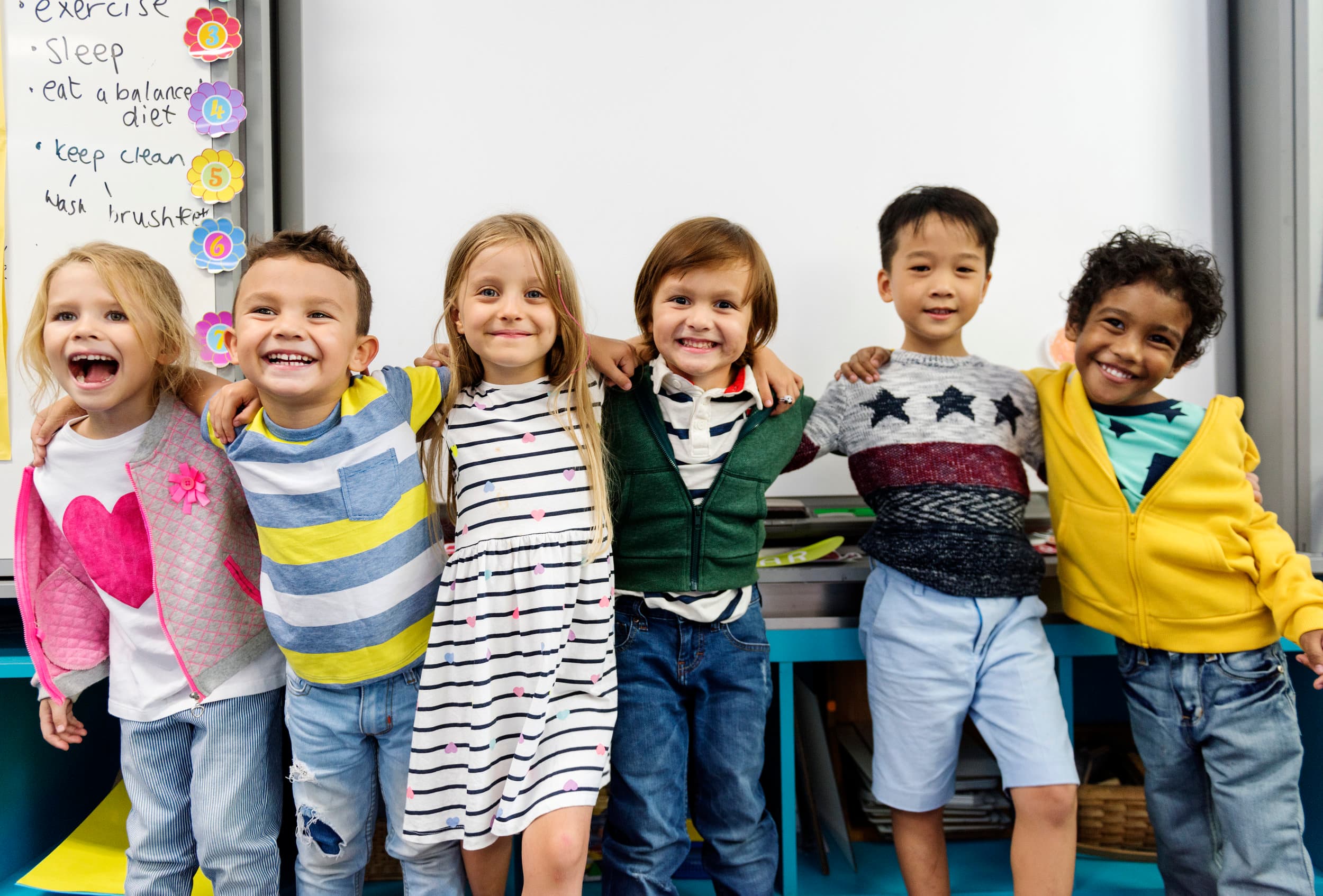 group-of-diverse-kindergarten-students-standing-P3QM736.jpg