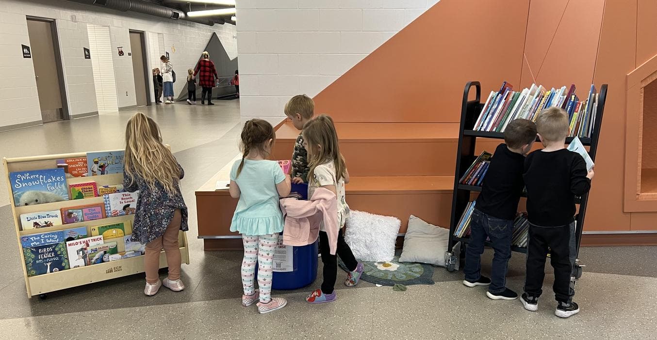 ECC students pick out books from their collection.