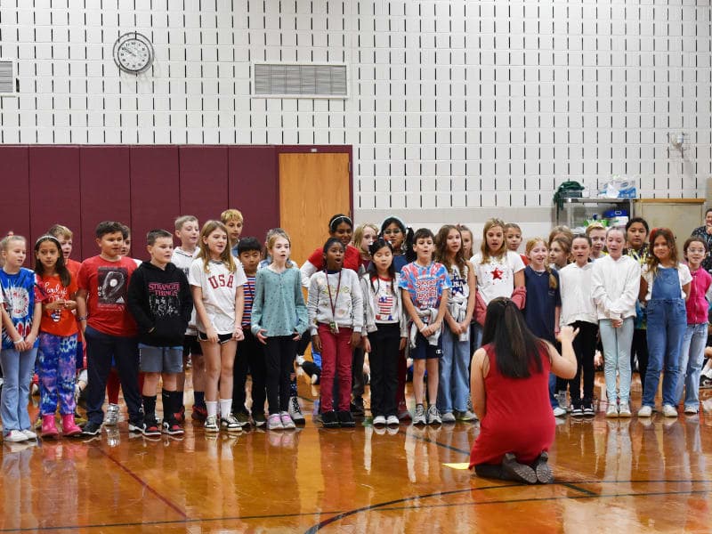 Students singing in the gym