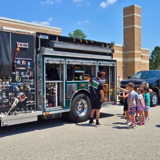 Students in front of a fire truck at 2026 Mobile Career Fair