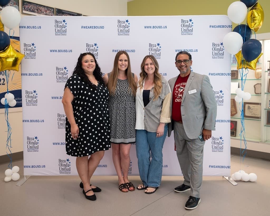 a group photo featuring Arovista's teacher of the year and employee of the year with Mr. Barrientos