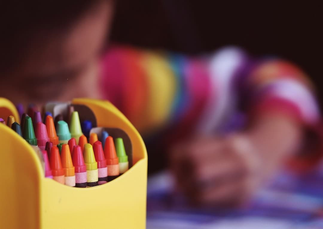 Michelle's Daycare and Preschool in Wharton TX Crayons beside child coloring