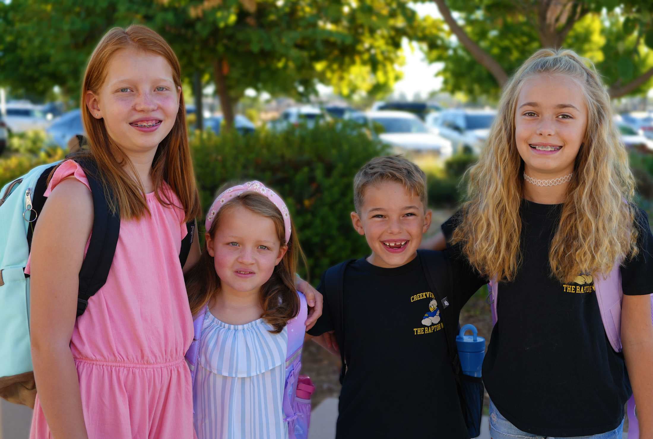 four students arms around each other