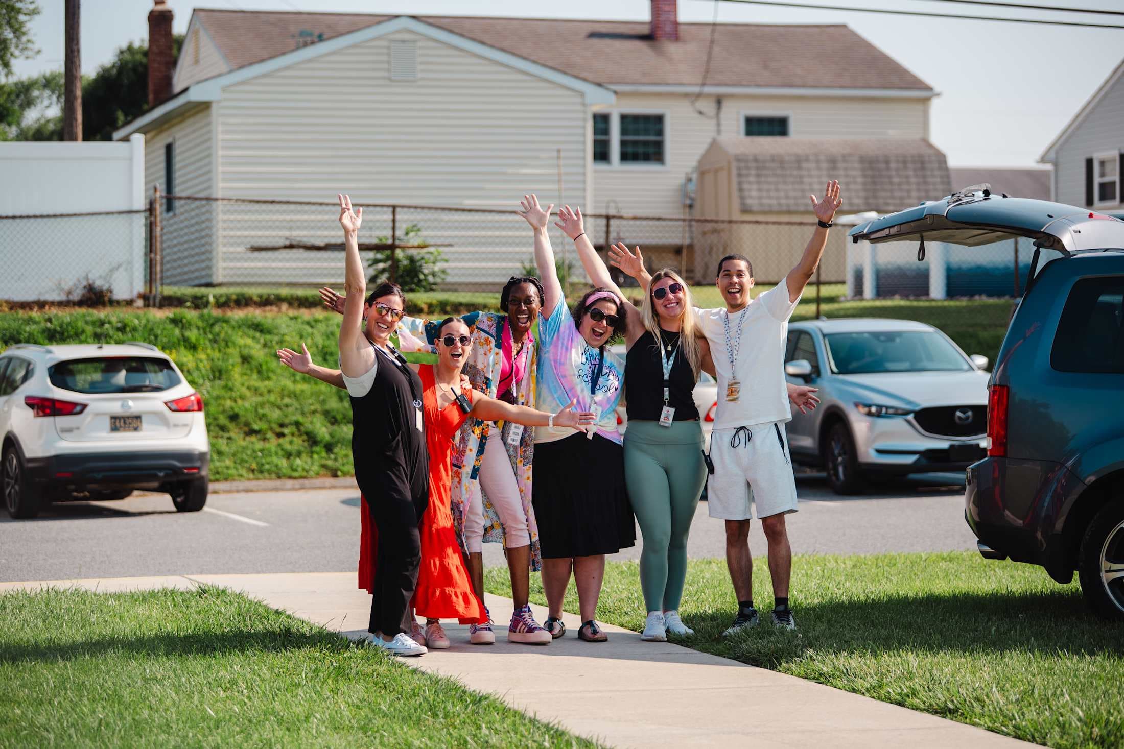 adults with arms in the air