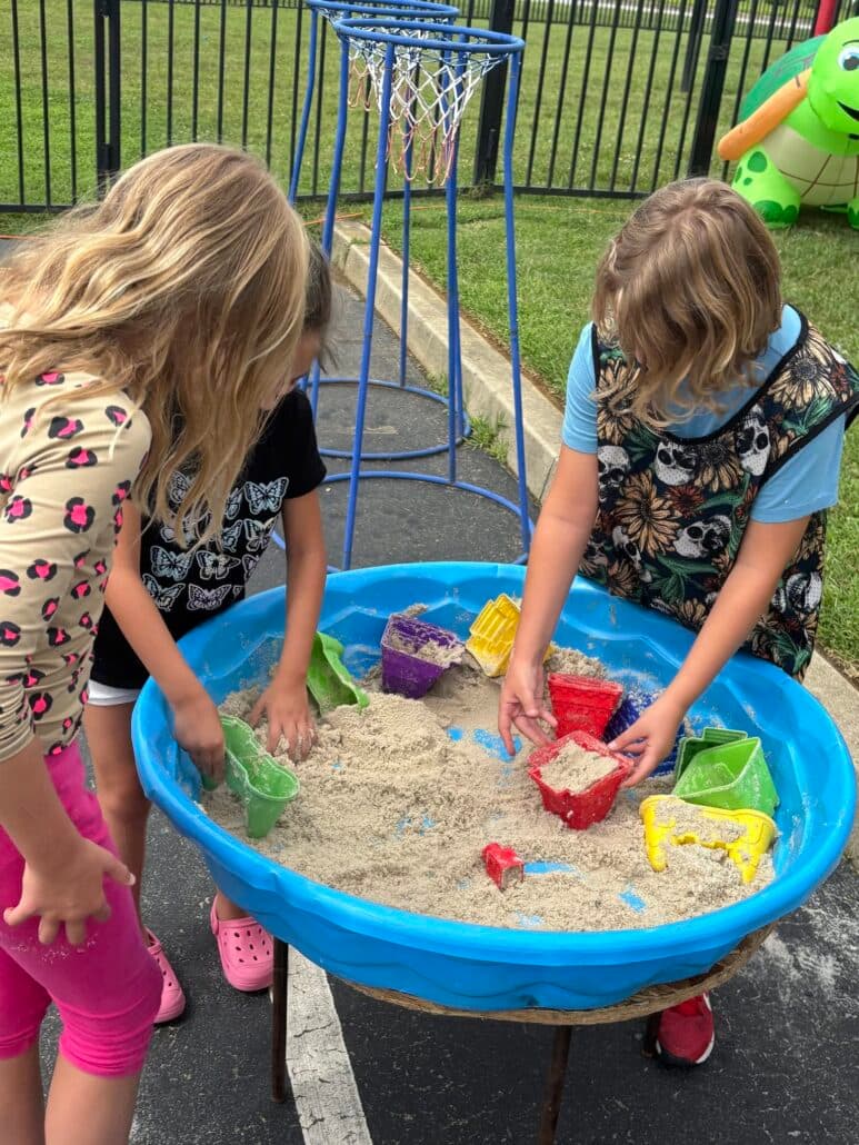 children playing outside in sand and water at preschool and daycare at cadence academy preschool smyrna, delaware