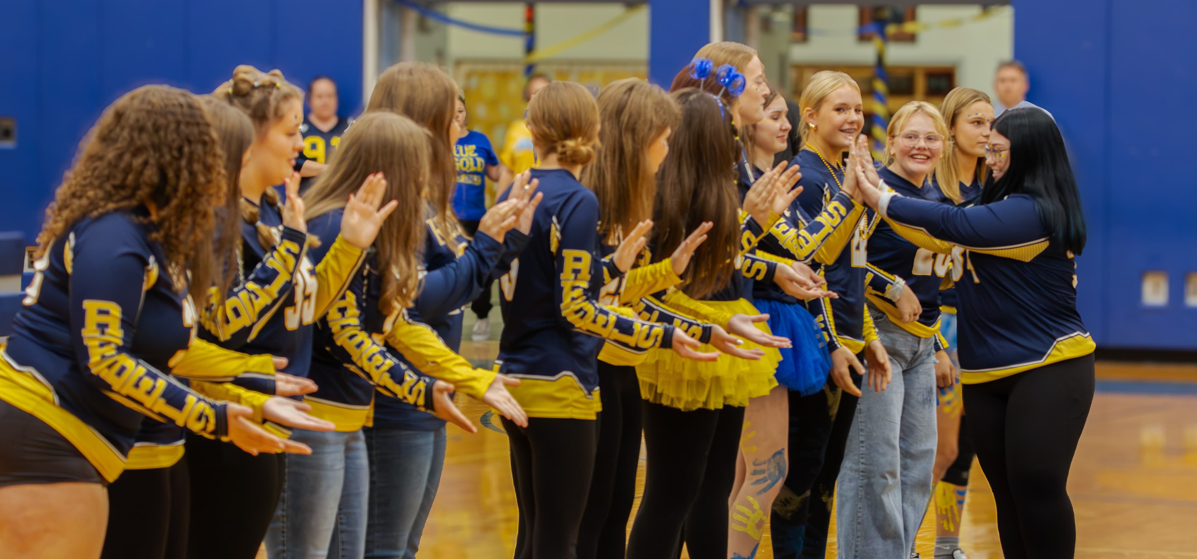 Students high five at pep rally