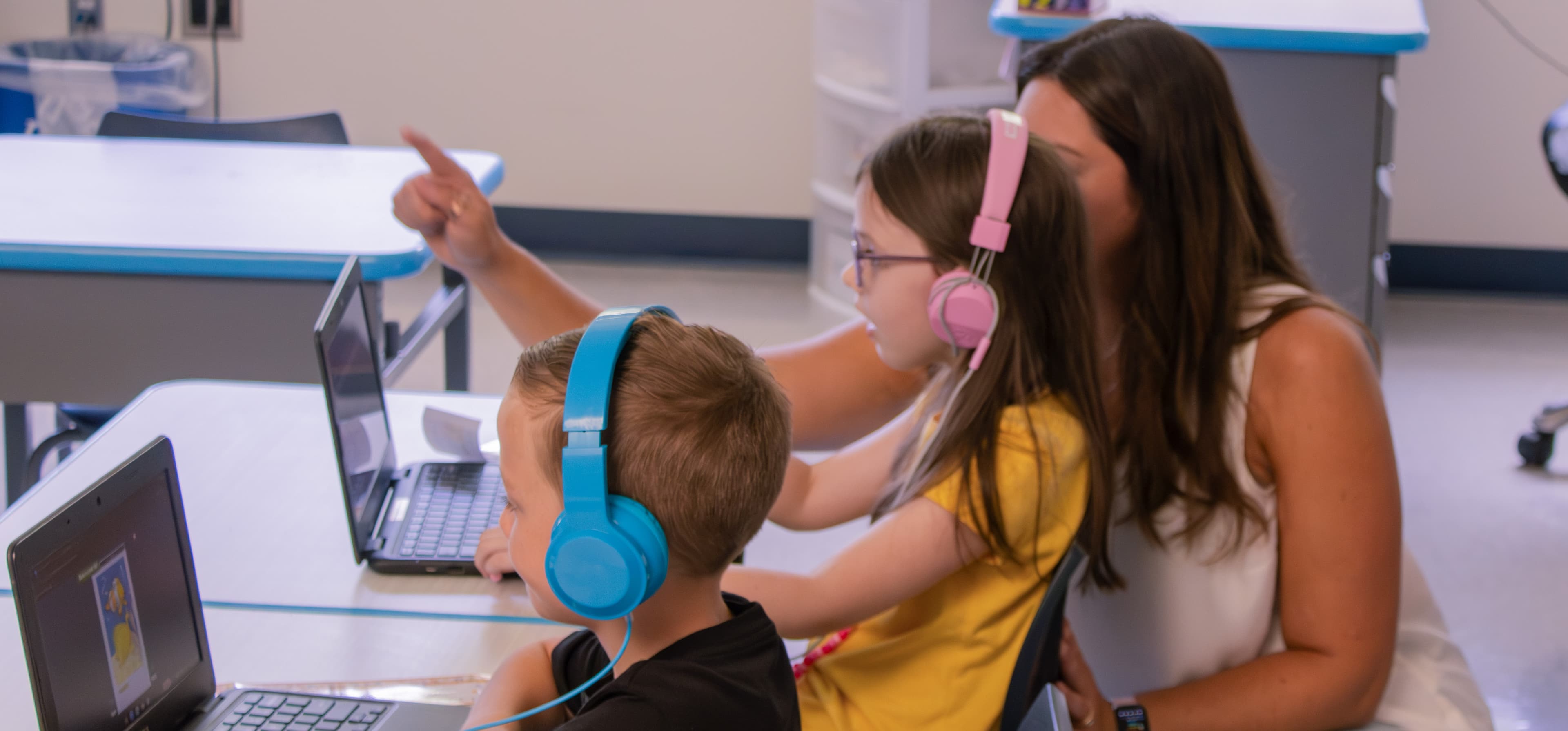 Teacher and students at laptops