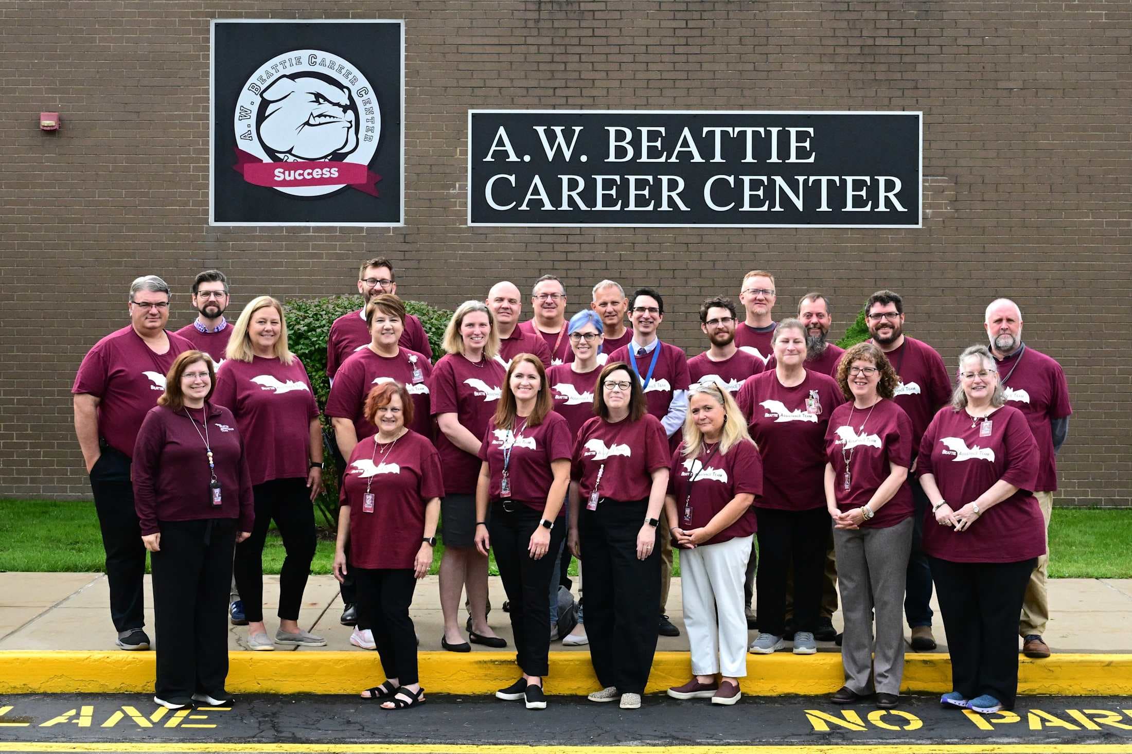 group of teachers outside of school building