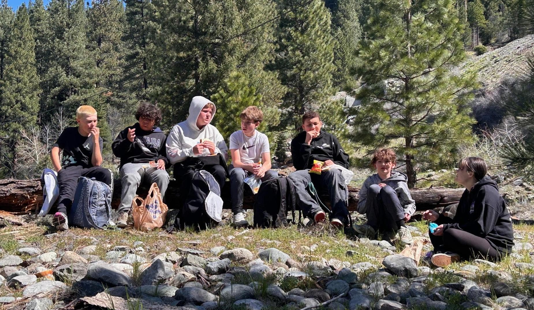 Group of students outside in a rocky meadow