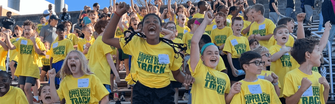 Photo of elementary students cheering at a track meet