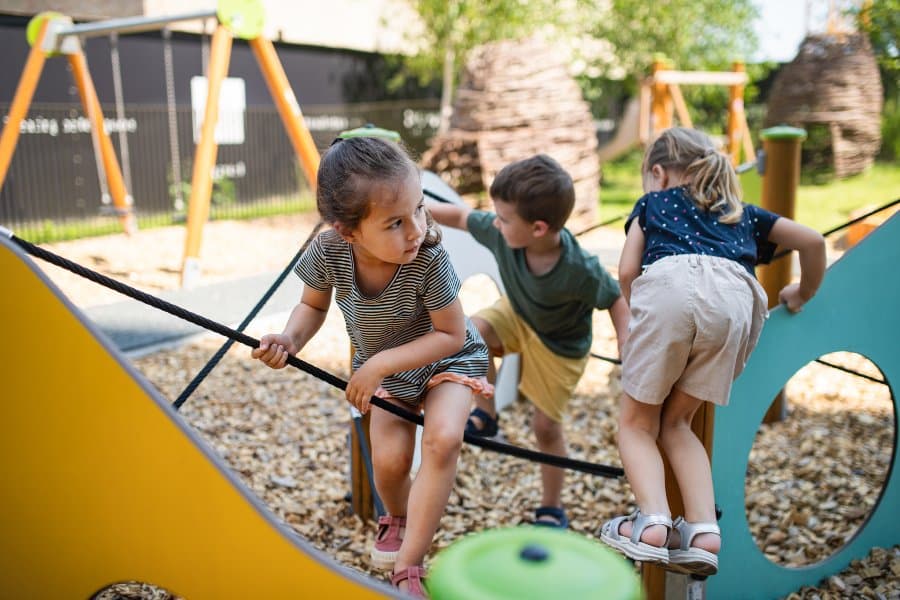 school children playing outdoors on playground outside