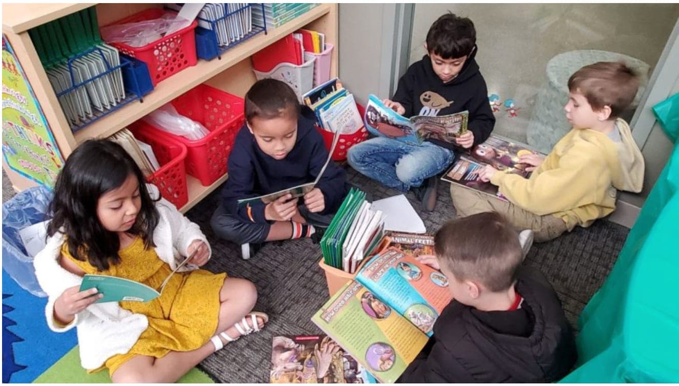 Students working at a classroom table.