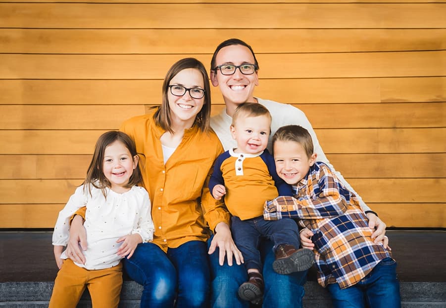 Young Caucasian family snuggles together for family portrait in Yuma Arizona