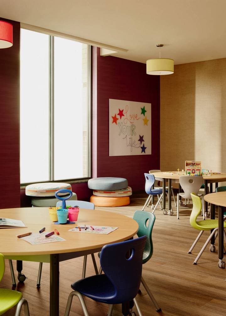 Otay Ranch Kids Academy colorful chairs and tables with crayons and papers on them.