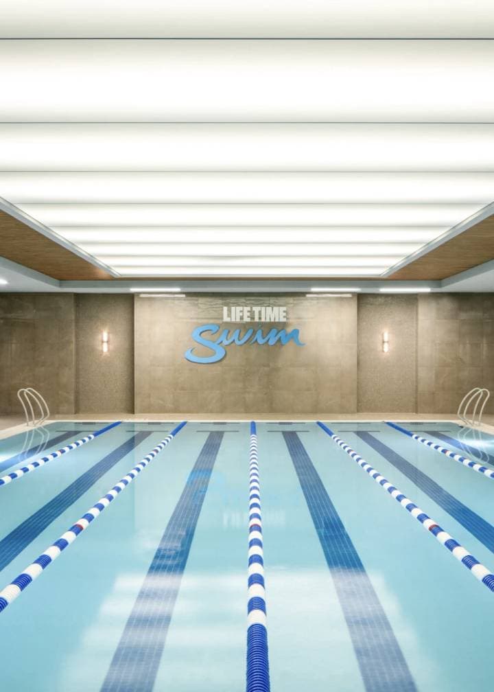Indoor swimming pool featuring a blue ceiling, creating a serene and inviting atmosphere for swimmers.